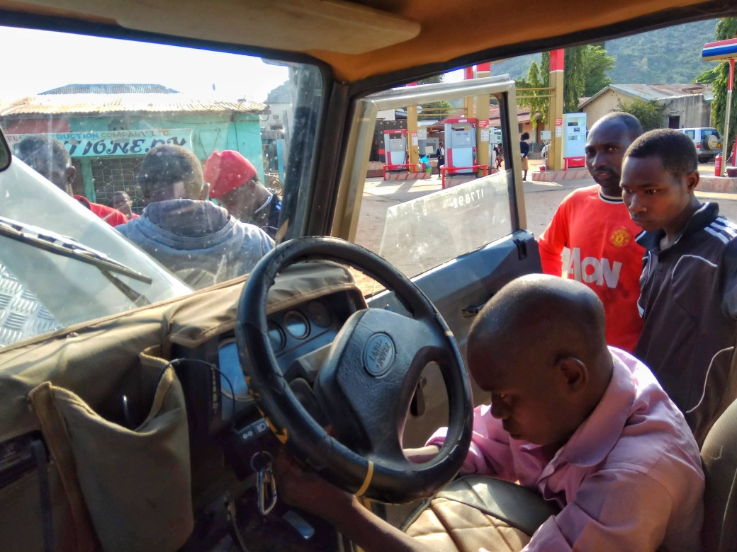 A mechanic fixing the windscreen mechanism of a landrover