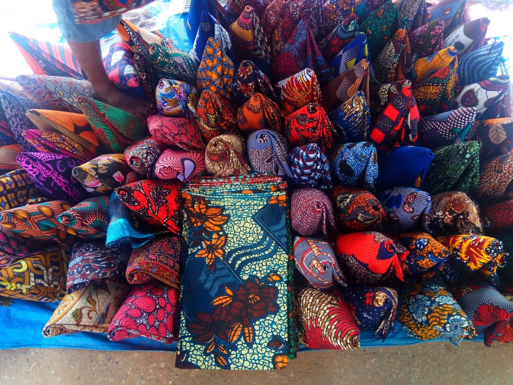 Colorful cloth folded into cones for display at the market
