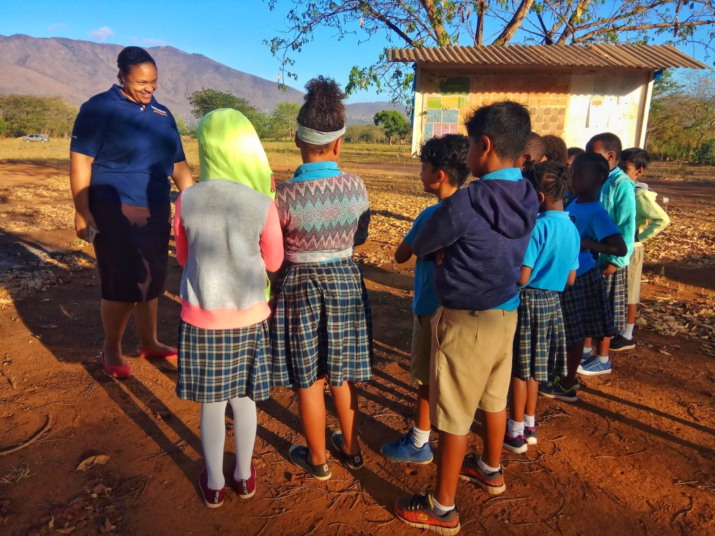 Lily speaking to schoolchildren before a minefield tour